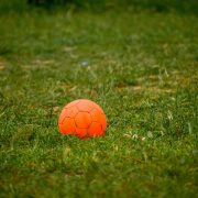 Orange ball on football pitch