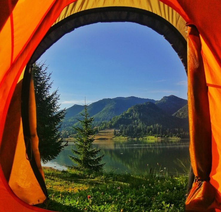 A mountain view from the door of a tent