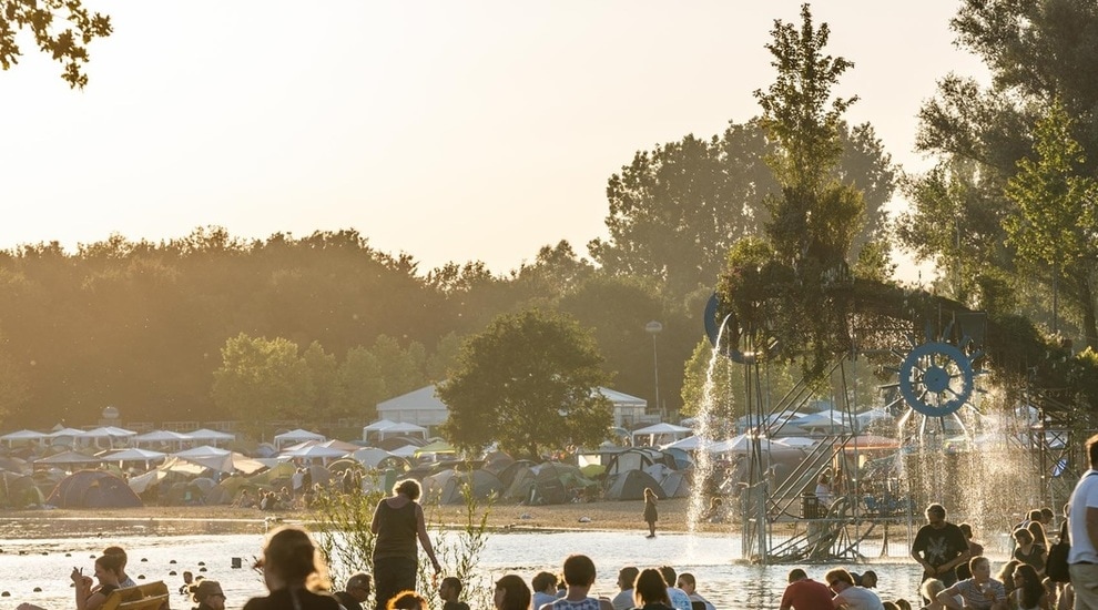 Campers gathered round a lake