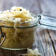Jar of sauerkraut on wooden table