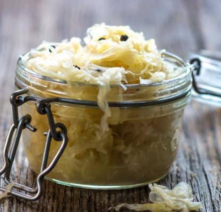 Jar of sauerkraut on wooden table