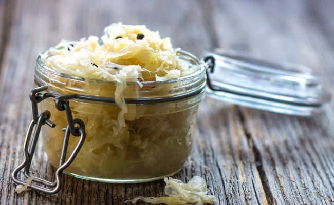 Jar of sauerkraut on wooden table