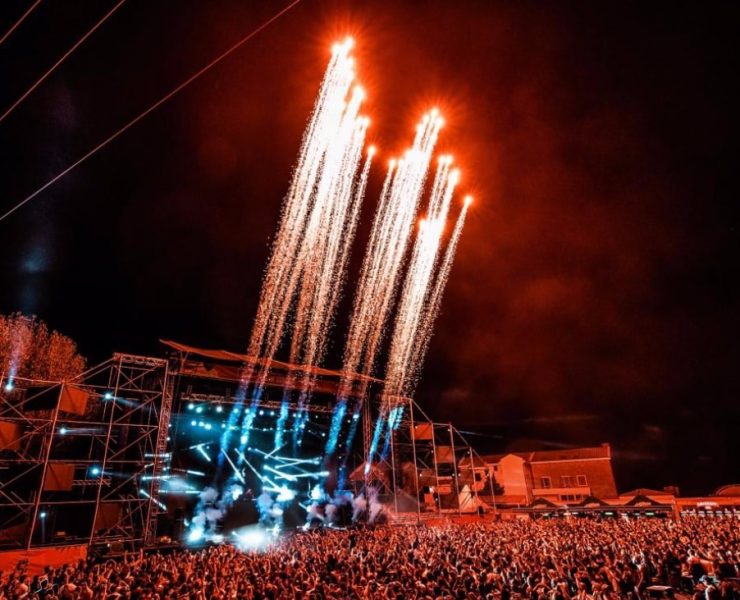 Fireworks blast skywards from an outdoor music stage