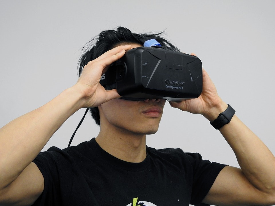 A man looks through a virtual reality mask